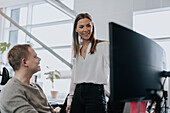 Man and woman talking in office