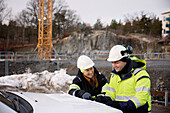 Engineers talking at building site