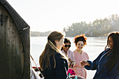 Smiling women wearing dressing gown at water