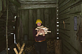 Woman carrying firewood in shed