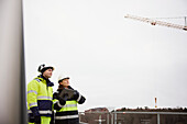 Engineers talking at building site