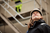 Female engineer standing at building site