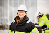 Female engineer standing at building site