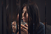 Digital composite of pensive woman drinking tea