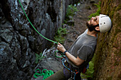 View of rock climbers holding rope