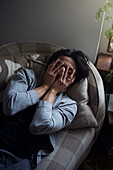 Man facing depression with hands covering his face