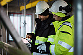 Male and female engineer working at construction site