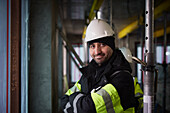 Portrait of smiling male engineer at construction site