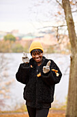 Smiling young woman showing peace sign