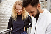 Smiling man and woman together looking away