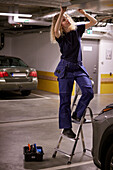 Woman checking air duck on parking