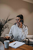 View of smiling woman using laptop