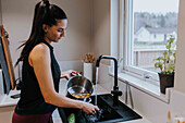 Woman standing near kitchen sink