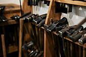 Various types of hammers hanging in workshop