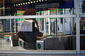 Woman at ticket barrier at train station