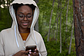 Smiling woman using cell phone