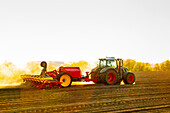 Tractor plowing field at spring