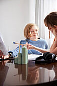 Mother helping daughter with homework