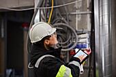 Female engineer using digital tablet at building site