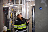 Female engineer using digital tablet at building site