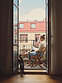 Woman reading book on balcony