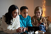 Children playing video games at home