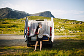 Woman standing in front of open van