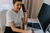 Smiling businesswoman talking via phone