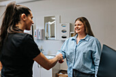 Female dentist greeting patient in office