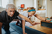 Senior couple doing yoga at home