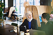 Businesswomen using digital tablet in cafe