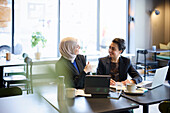Businesswomen talking in cafe