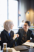 Businesswomen talking in cafe