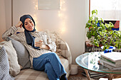 Woman on sofa using cell phone