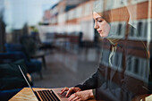 Woman in cafe using laptop