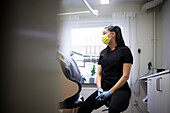 Female dentist sitting in office