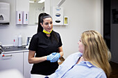 Female dentist with patient in office