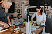 Family in kitchen preparing food
