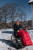Smiling woman sitting on wheelchair