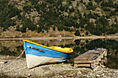 Chile, Aysen, Bertrand, baker River. Fishing boat on the shore of Lago Bertrand.