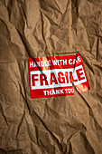 Fragile handle with care sticker on crushed package