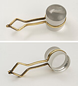 Stanhope magnifiers with brass handles on white background