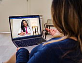 Woman having video call with doctor