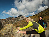 United States, Utah, American Fork, Couple stretching in mountain landscape