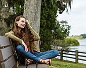 Smiling woman sitting on bench 