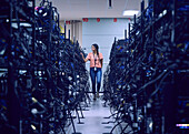 Female technician working in server room