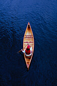 Overhead view of woman paddling canoe on Lake Placid