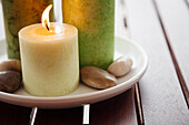 Close-up of candles and stones on plate