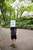 Girl (2-3) wearing robot mask in park