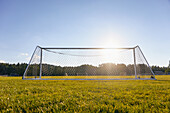 Soccer goal in field in sunshine